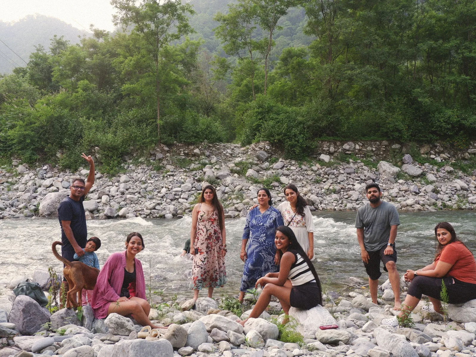 Group of friends on the rocky bank of the Ramganga river
