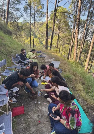Group painting stones together on a forest path