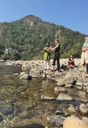 Riverside session on the rocks under a forested mountain