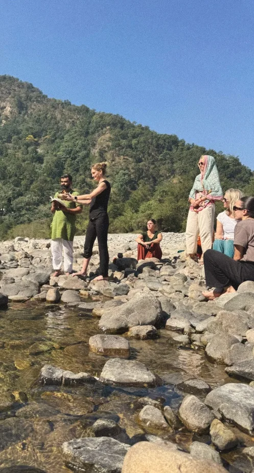 Guided practice by the river with guests on the stones